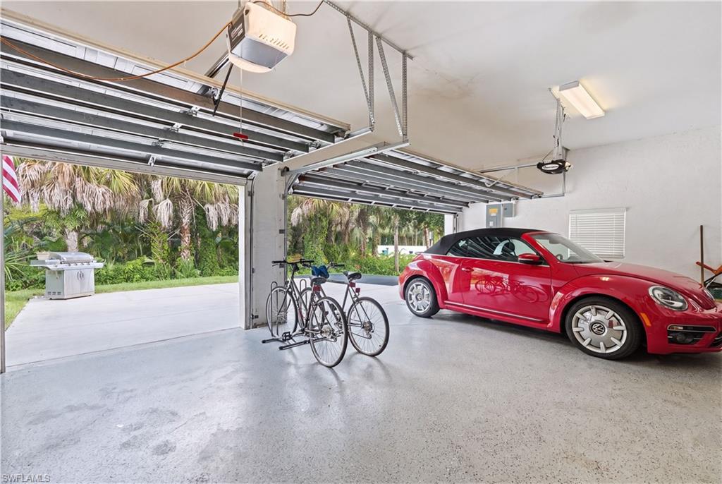 Three-car garage featuring automatic openers and durable epoxy flooring