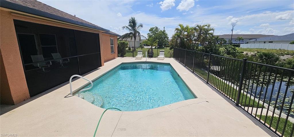 Rectangular swimming pool with a concrete surround and integrated steps
