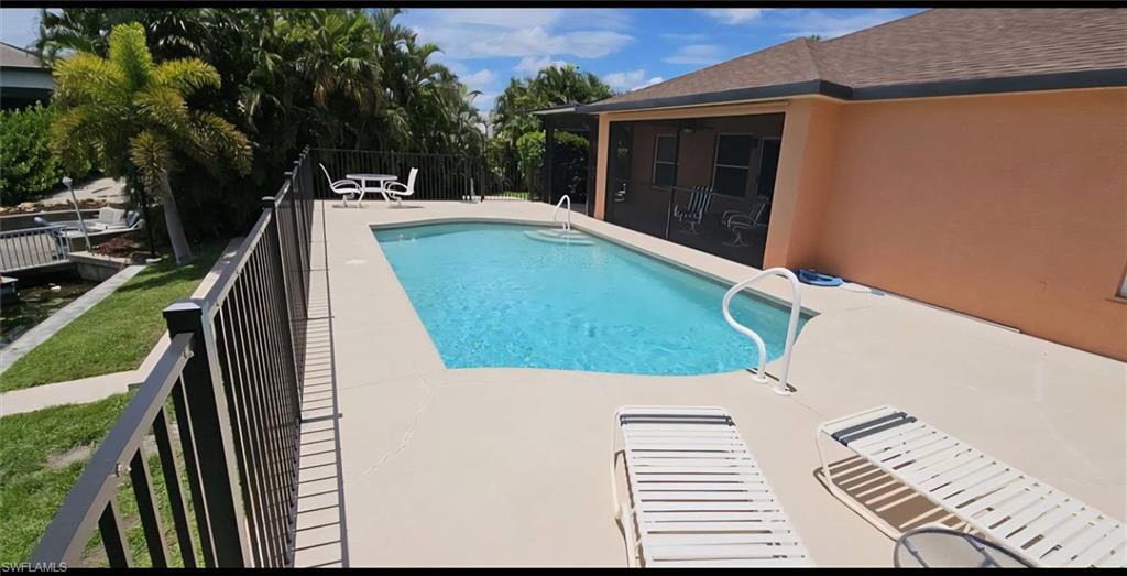 Outdoor swimming pool with integrated steps, surrounded by a spacious pool deck