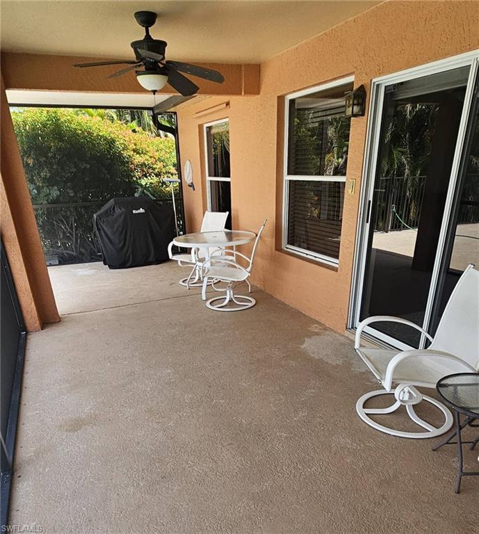 Screened patio with a textured concrete floor, recessed lighting, and a ceiling fan