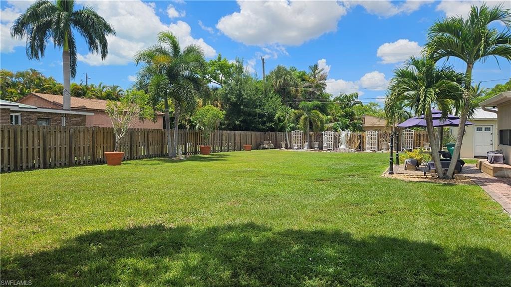 Lot looking front to back. House, shed and driveway are on the lot next door - 865 103rd Ave N.