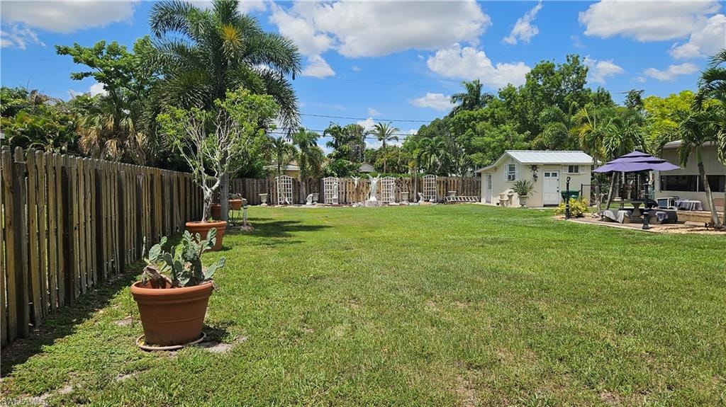 Lot looking front to back. House, shed and driveway are on the lot next door - 865 103rd Ave N.