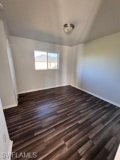 Unfurnished room with dark wood-type flooring