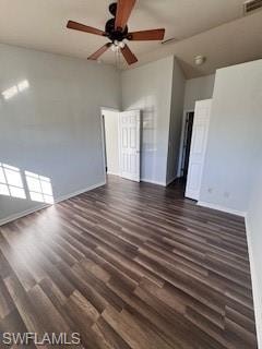Spare room featuring ceiling fan, dark hardwood / wood-style flooring, and a towering ceiling