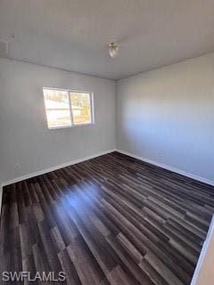 Spare room with dark wood-type flooring