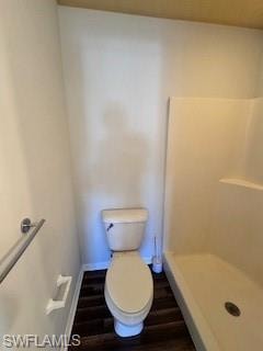 Bathroom with hardwood / wood-style floors and walk in shower
