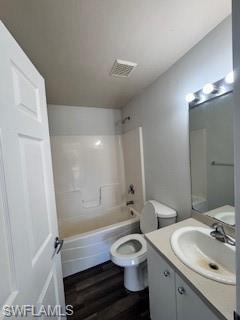 Full bathroom featuring shower / tub combination, vanity, hardwood / wood-style flooring, and toilet