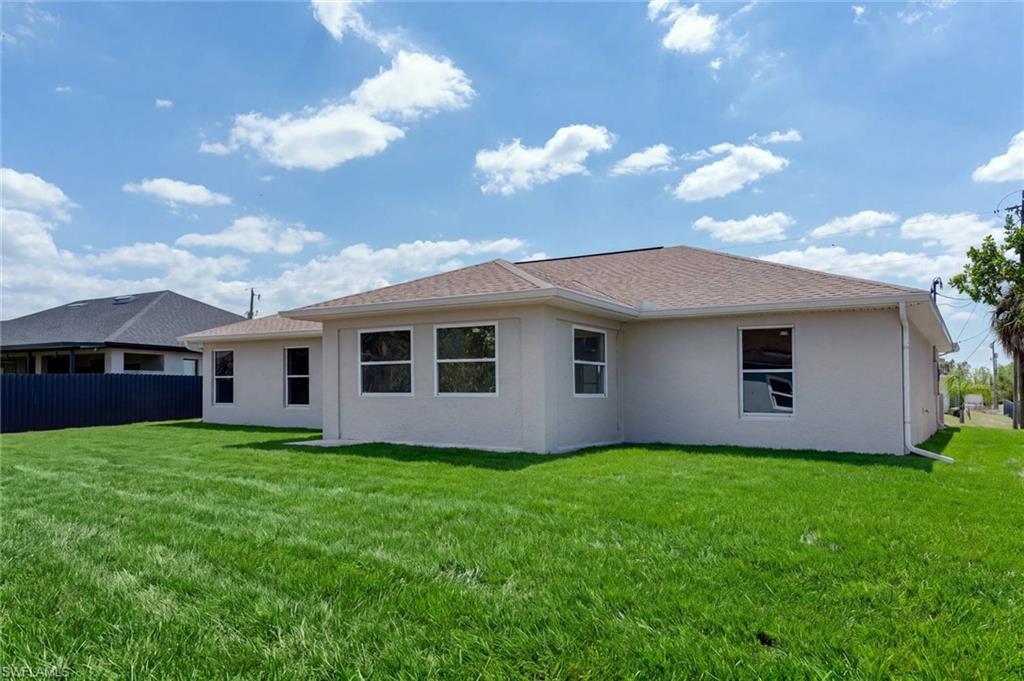 Modern single-story residence with a clean white exterior, pitched roof with dimensional shingles, and multiple large window openings providing natural light