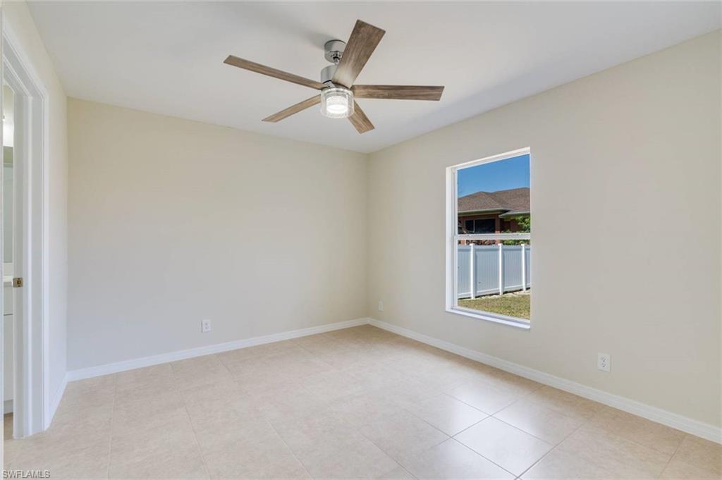 Bright, open room with tile flooring, neutral wall finishes, and abundant natural light from dual windows