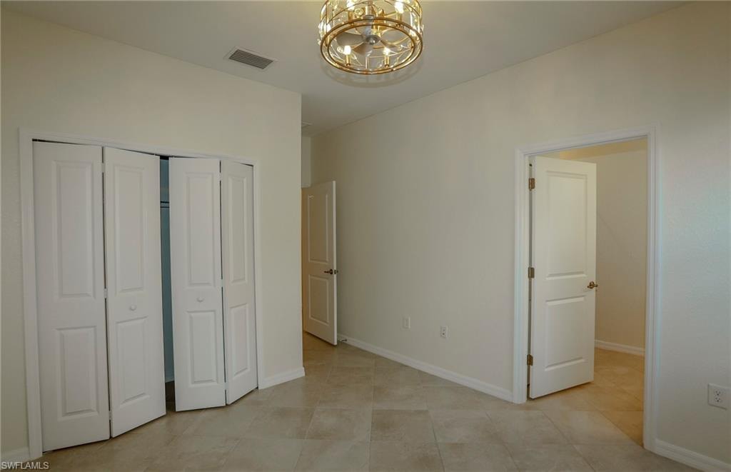 Recessed lighting, tile flooring, bi-fold closet doors, and solid interior doors