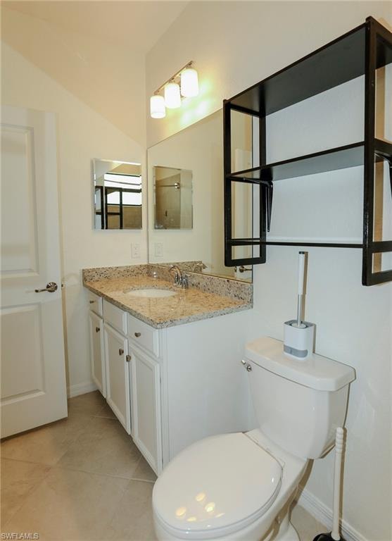 Vanity with a granite countertop, undermount sink, and chrome-finish faucet
