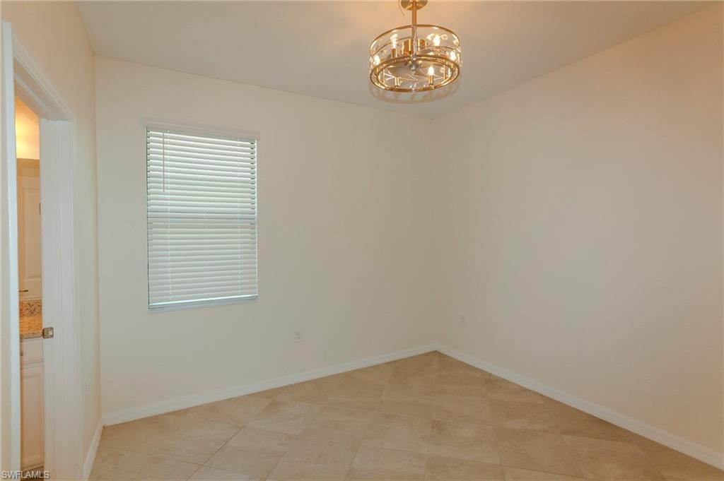 Recessed window with blinds, ceiling-mounted light fixture, and tile flooring