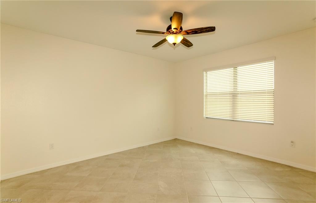 Ceramic tile flooring, neutral wall tones, window with horizontal blinds, and a ceiling fan with integrated lighting