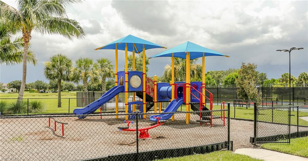 Recreational playground area featuring multiple slides, climbing structures, and a spring rider