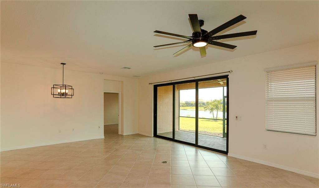 Expansive room featuring tile flooring, a contemporary ceiling fan, and a modern geometric pendant light fixture