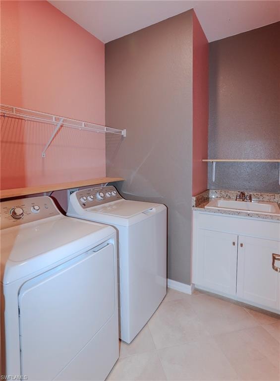 Laundry area featuring tile flooring, white cabinetry, and a countertop with an integrated sink