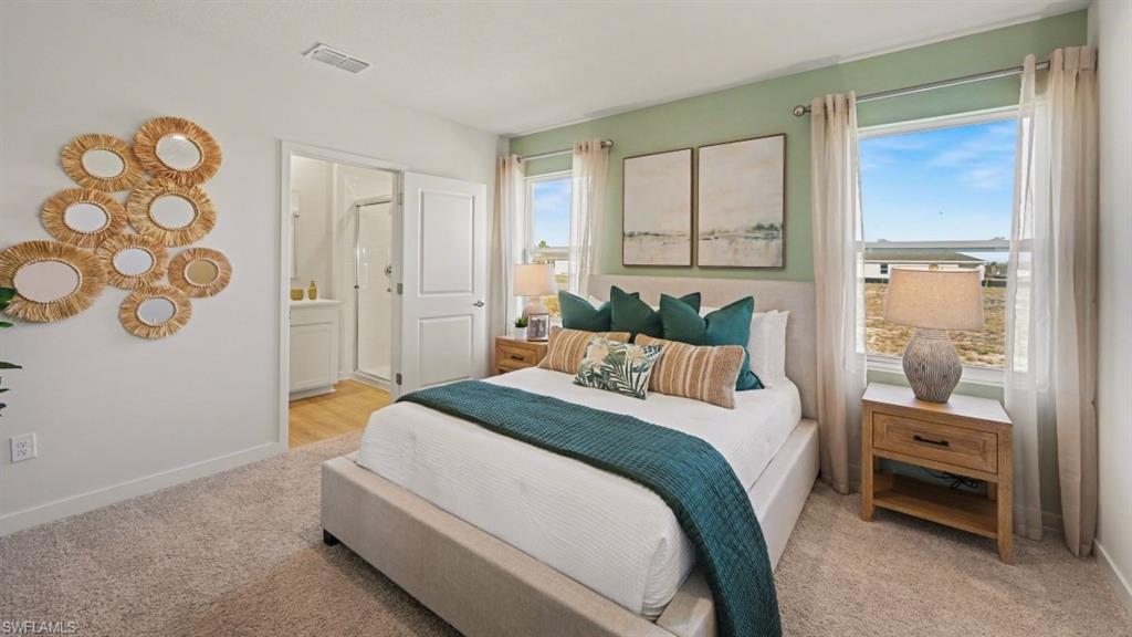 Carpeted bedroom with a light green accent wall and two large windows