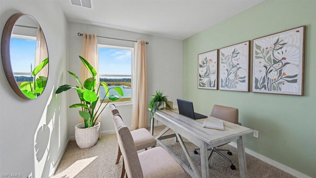 Dedicated office space featuring a large window with water scenery