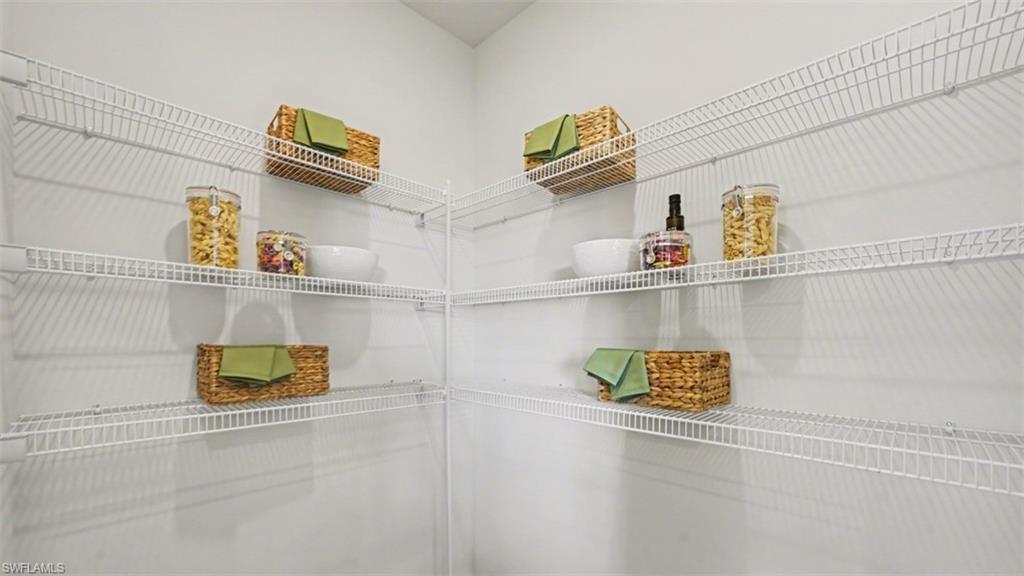 Corner pantry with multiple levels of white wire shelving