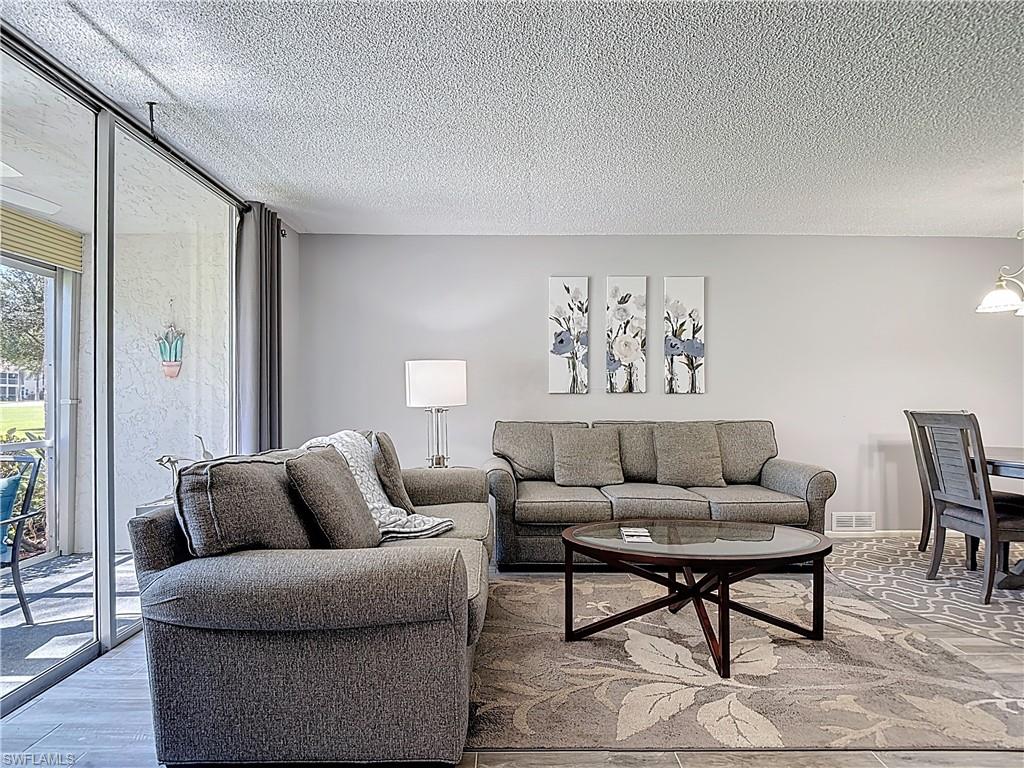Living area featuring a textured ceiling and wood finished floors