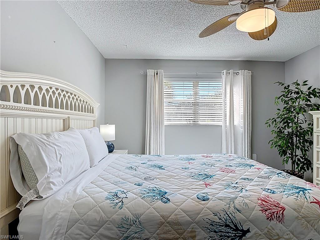 Bedroom featuring a textured ceiling and a ceiling fan