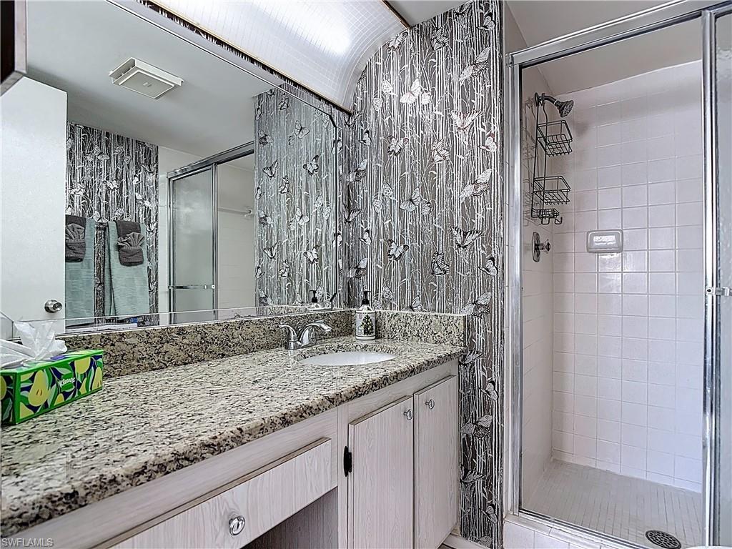 Bathroom with vanity and a shower stall