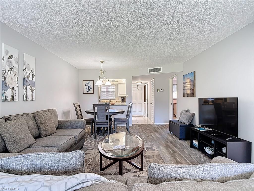 Living room with wood finished floors and a textured ceiling