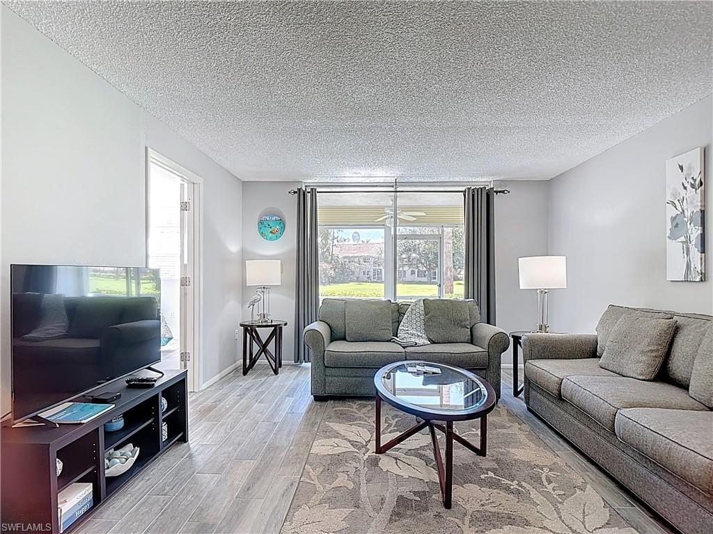 Living room featuring wood finished floors and a textured ceiling