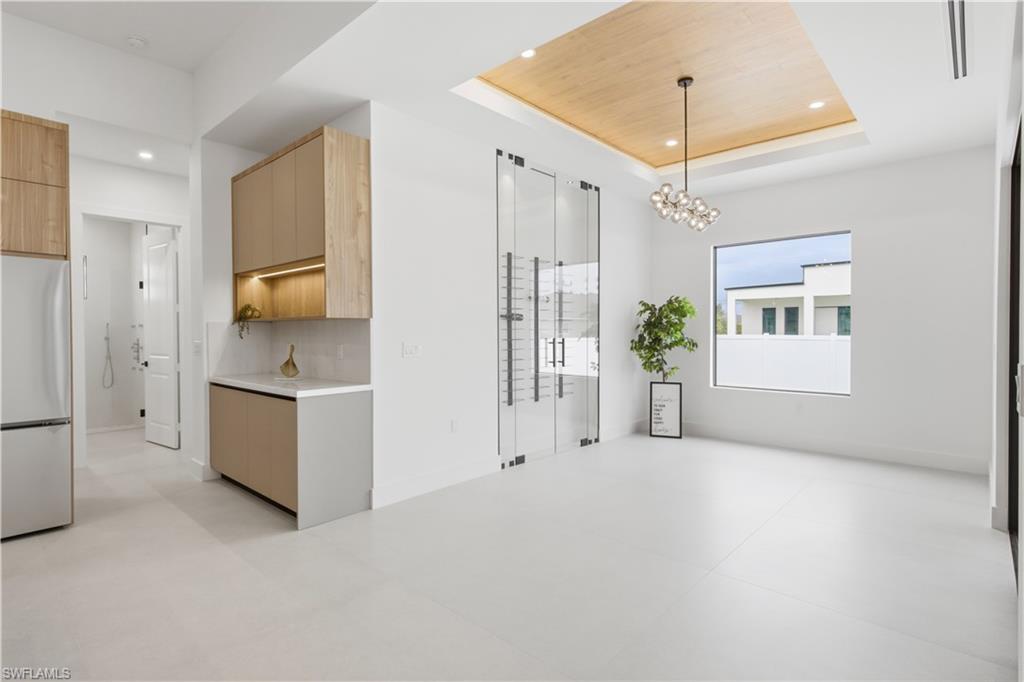 Formal dining area is highlighted by an impressive glass-enclosed wine display, adding a sophisticated focal point for entertaining!