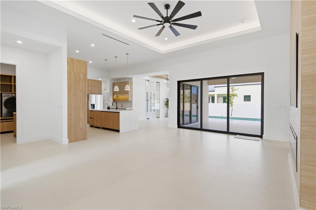Oversized sliding glass doors provide abundant natural light and seamless access to the pool area.