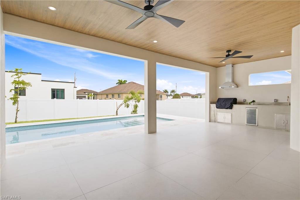 Outside oasis w/ expansive covered lanai showcasing a beautiful flat wood ceiling