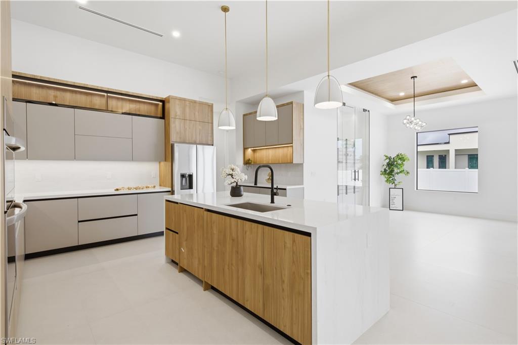 Built-in stainless-steel appliances, induction cooktop and pot filler complete this beautifully appointed chef-inspired kitchen.