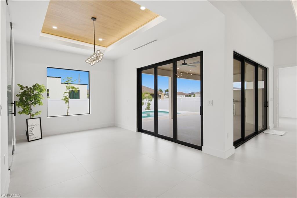 Light-filled dining area offers seamless indoor-outdoor flow with direct access to the pool and lanai.