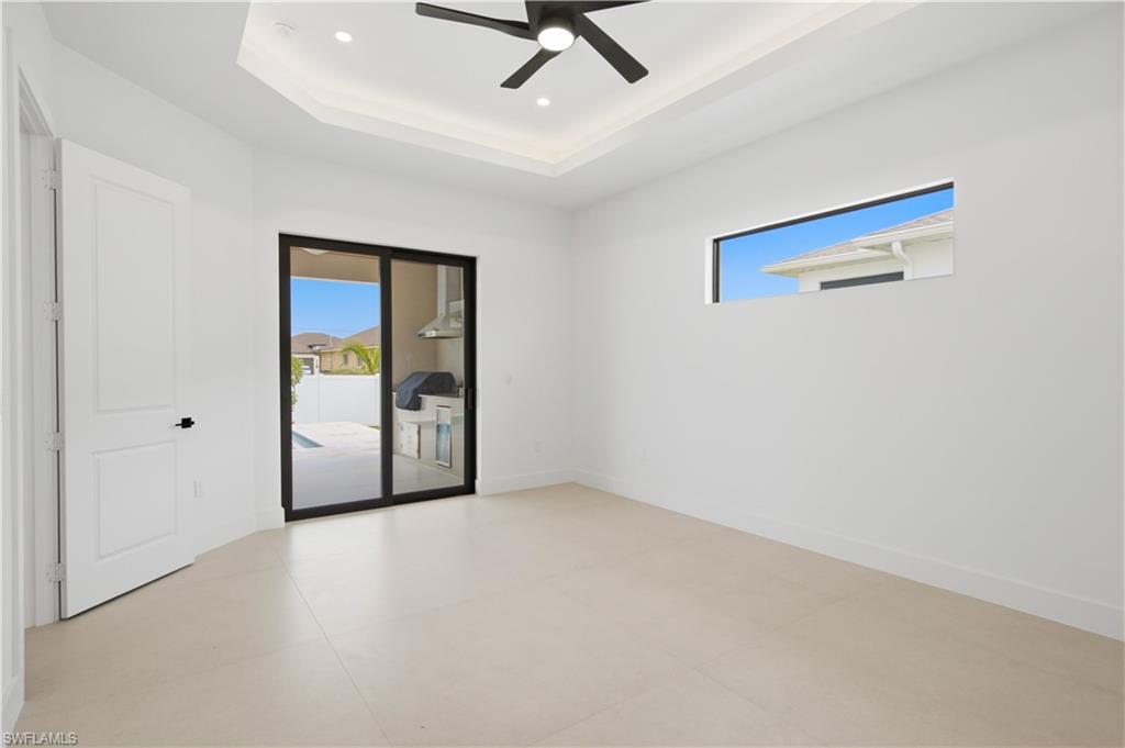 Luxurious owner's suite is a true private retreat featuring lanai access, custom illuminated walk-in closets