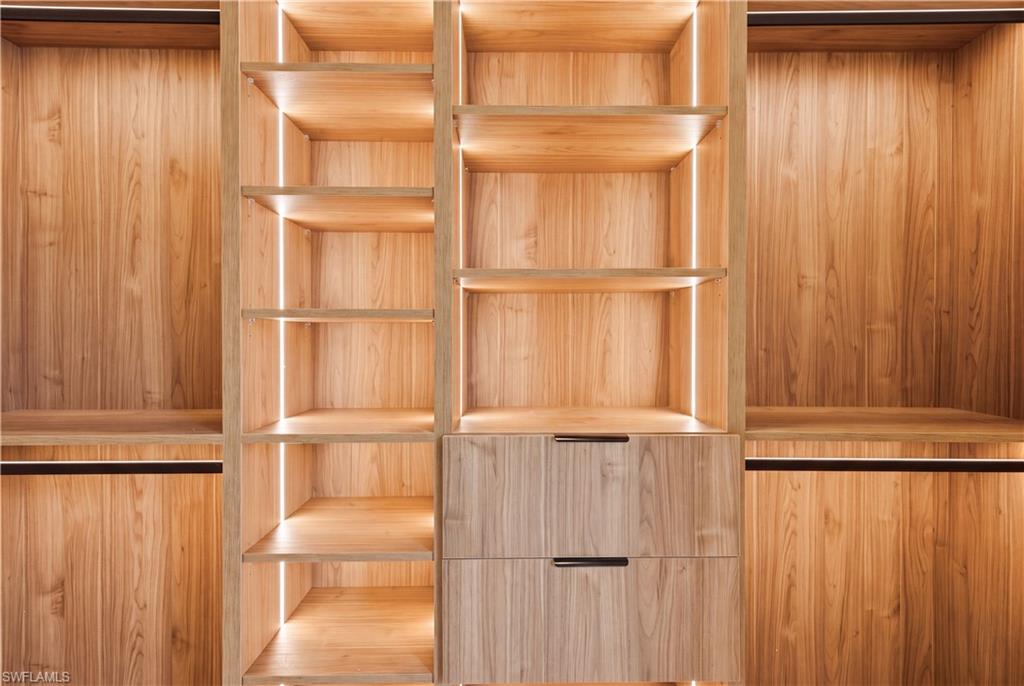 Integrated LED lighting and built-in drawers elevate the closets with a luxurious boutique-style feel.
