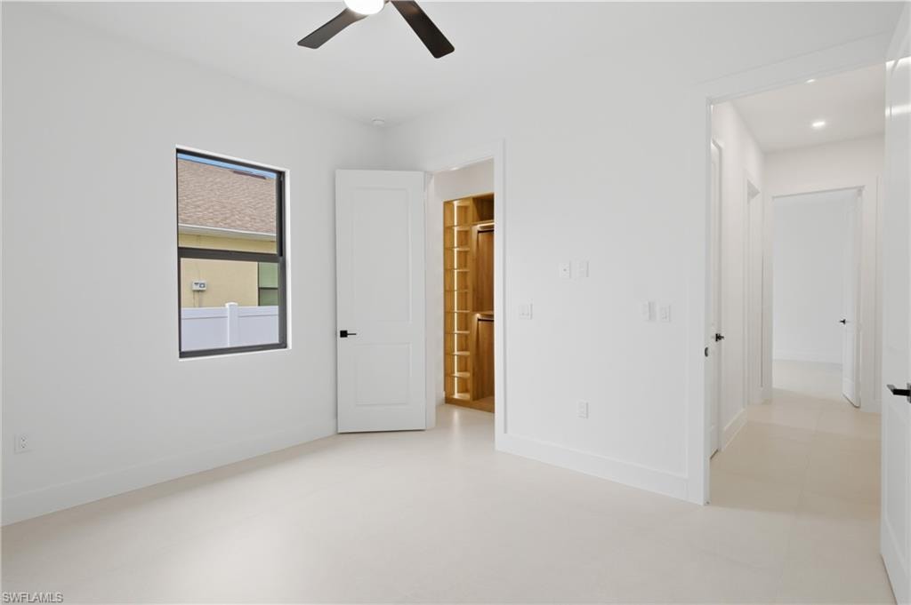 Spacious third bedroom offers comfort and abundant natural light.