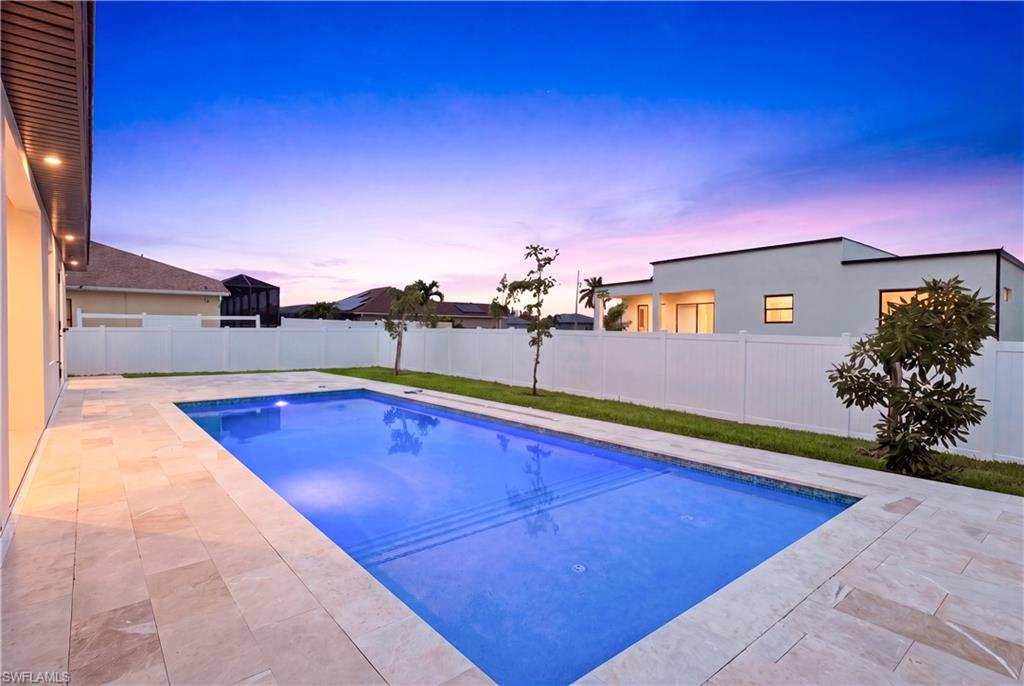 Sparkling pool with elegant marble deck creates the perfect setting for relaxing and entertaining.