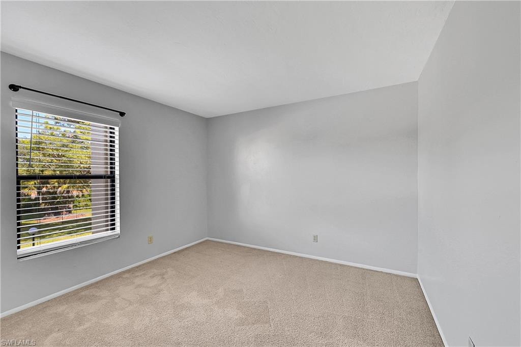 Empty room with baseboards and light carpet