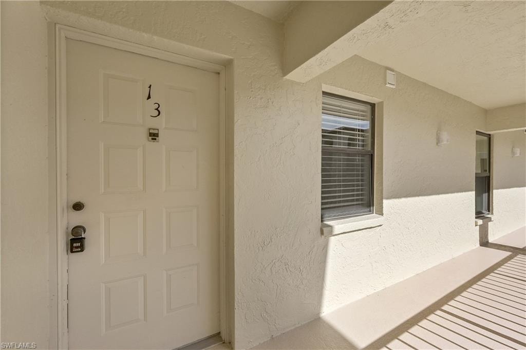 View of exterior entry featuring stucco siding
