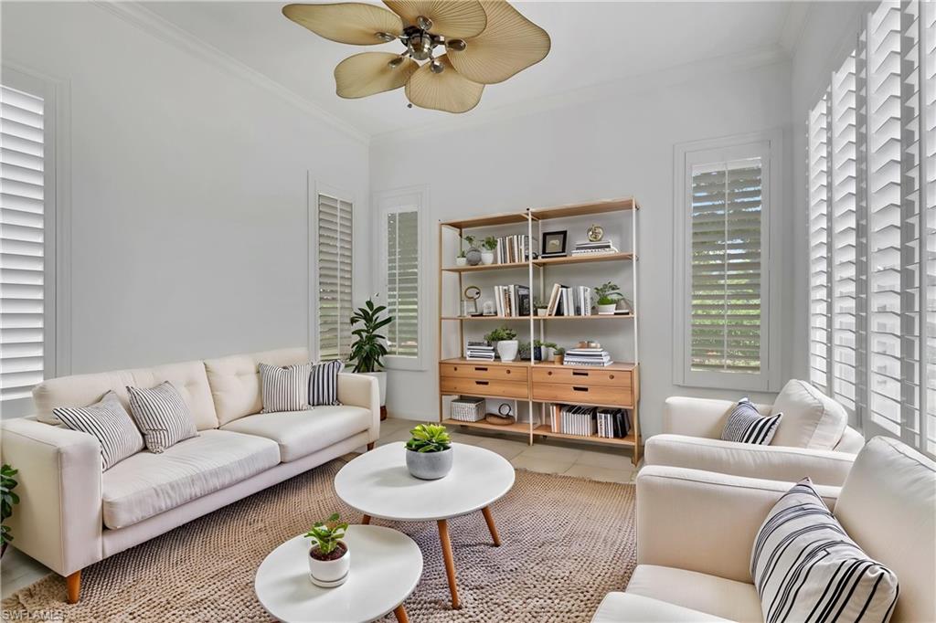 Virtually staged family room or dining room adjacent to open kitchen. Features windows with garden view.