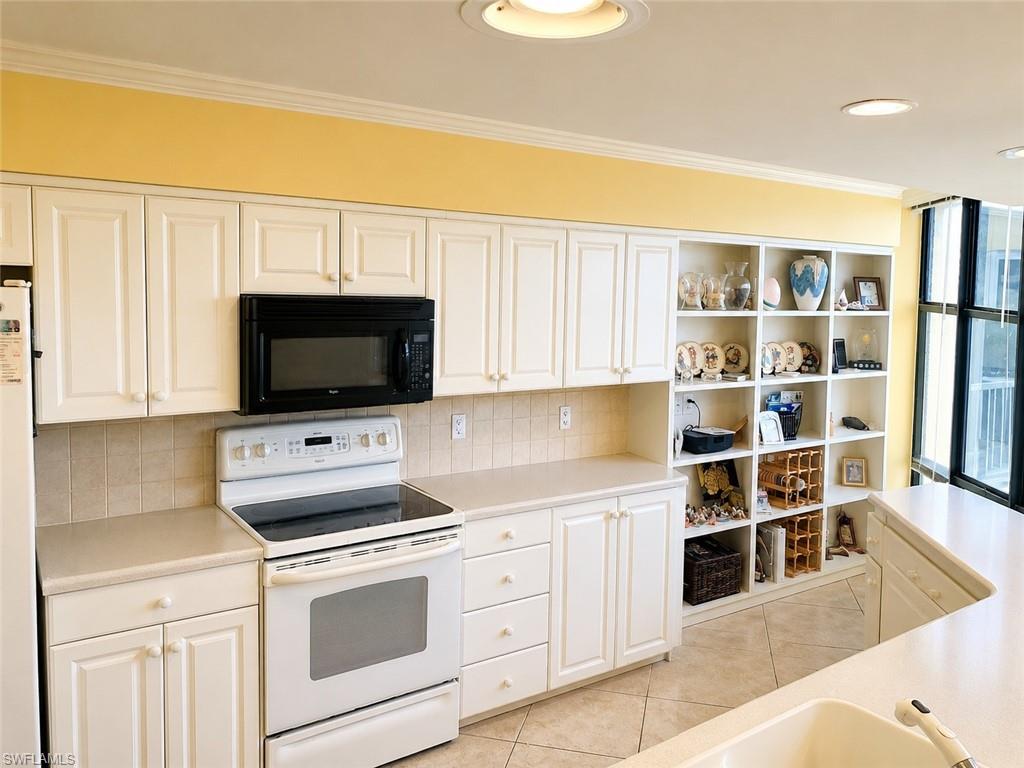 *Enhanced photo Kitchen featuring white cabinetry with brushed nickel hardware, a white electric range, and an over-range microwave