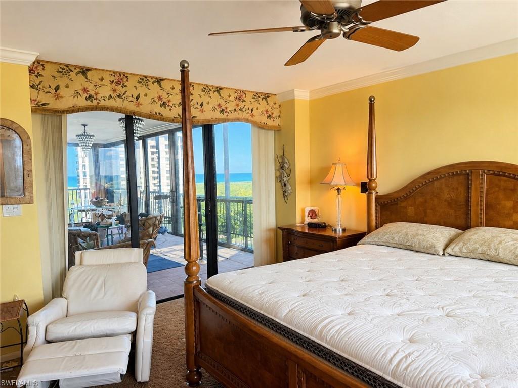 Room featuring an *Enhanced photo overhead ceiling fan, crown molding, and a built-in balcony with expansive ocean scenery