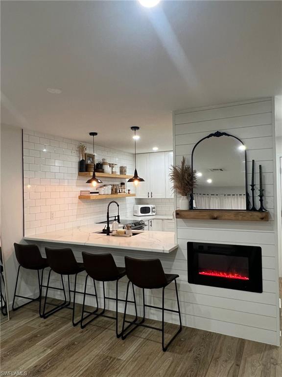 Kitchen island with a white countertop and a matte black faucet