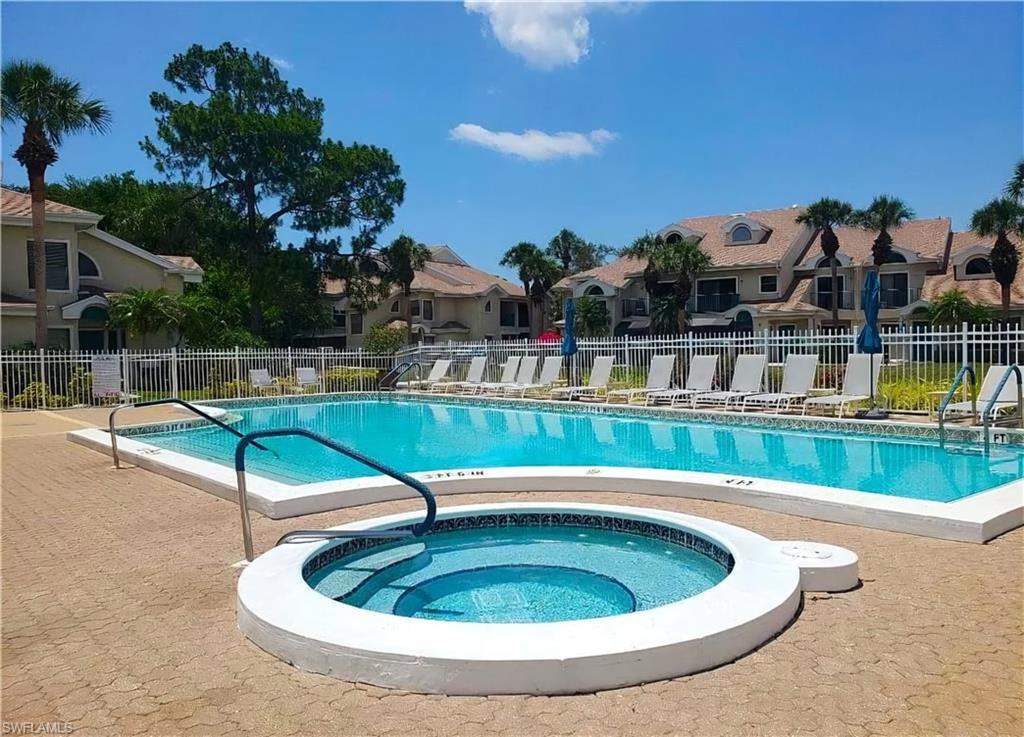 Outdoor swimming pool featuring a connected circular spa