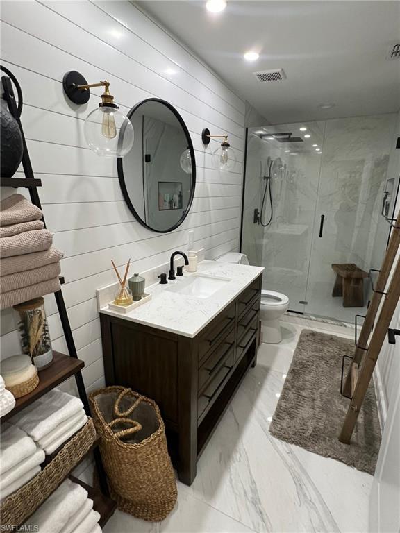 White shiplap accent wall with dual globe sconces