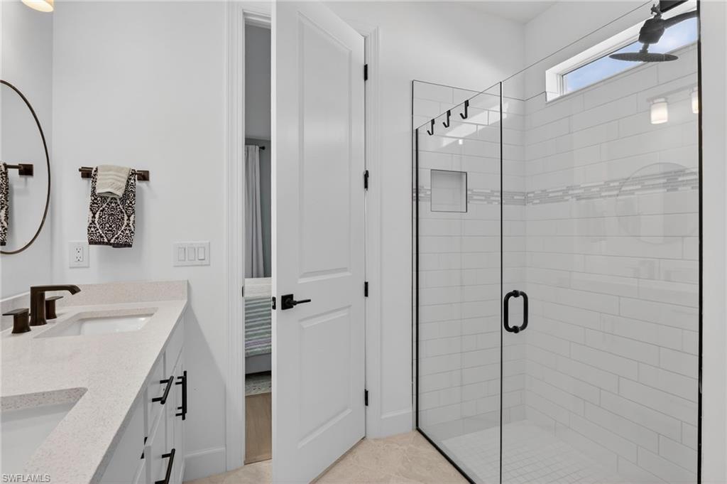 Shower enclosure with clear glass paneling and a dark-framed door