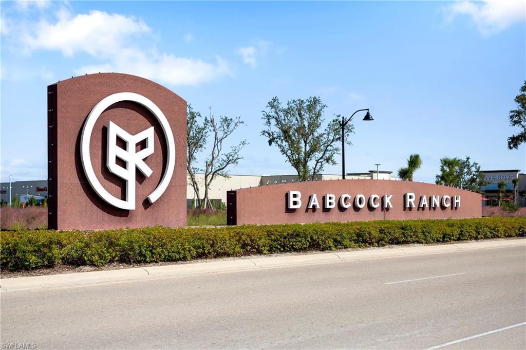 Entryway signage for Babcock Ranch featuring a prominent circular logo and raised lettering