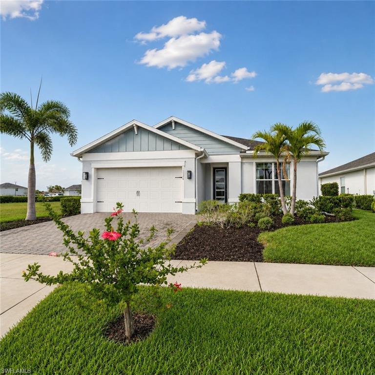 Front of home with wide driveway and 4 ft. ext. in garage