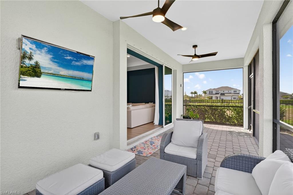 Screened patio featuring paver flooring and dual ceiling fans