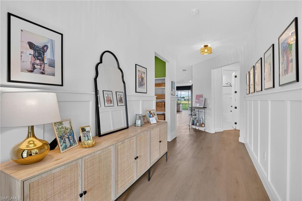 Entryway featuring board and batten wainscoting and wood-finish flooring